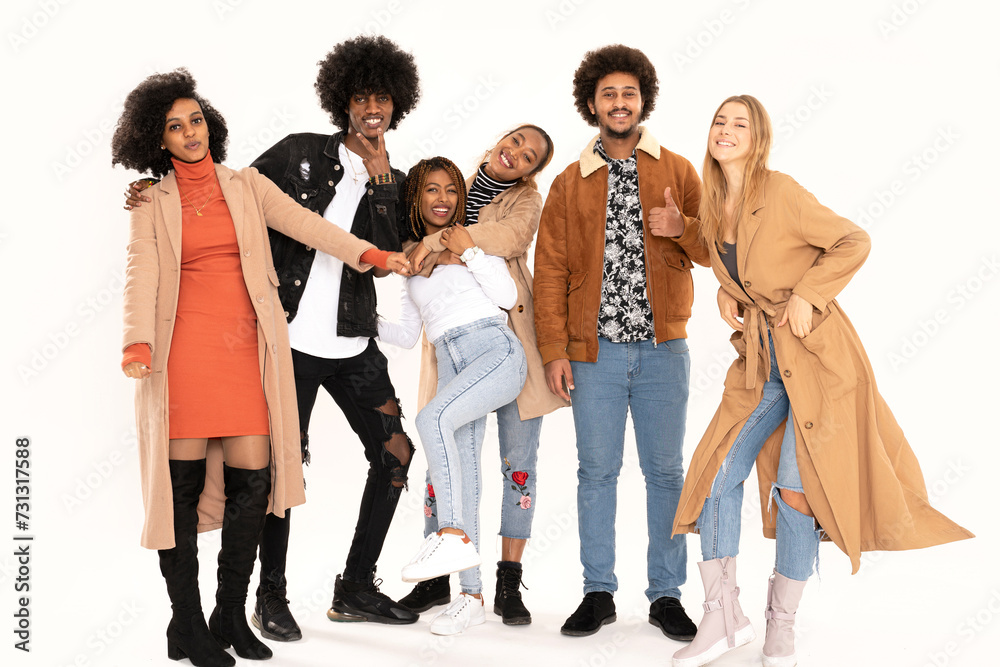 Obraz premium Happy multiethnic group of friends posing on white studio background