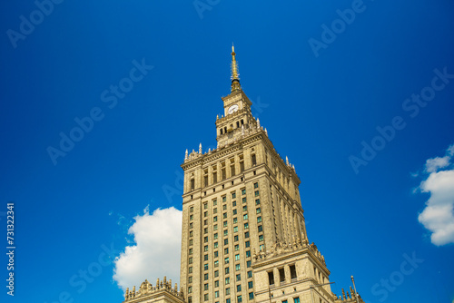 Historic Palace of Culture and Science tower in Warsaw under clear blue sky photo