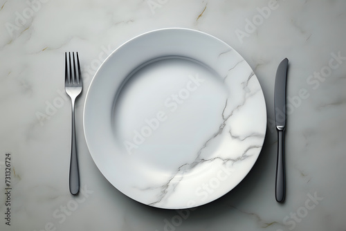 Elegant Table Setting with Marble Background. A sophisticated table setting featuring a pristine white plate with a marble design, accompanied by sleek silverware, perfect for dining