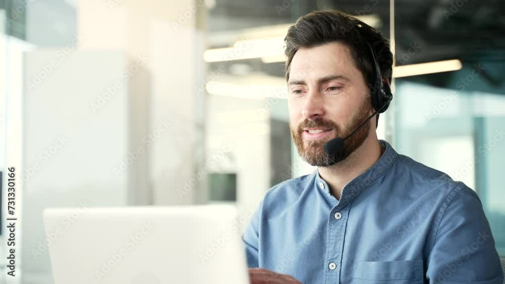 Corporate operator who works in customer support speaks on a video call using a laptop computer. Call center agent in wireless headset helping customer with complaints in office. Online consultation