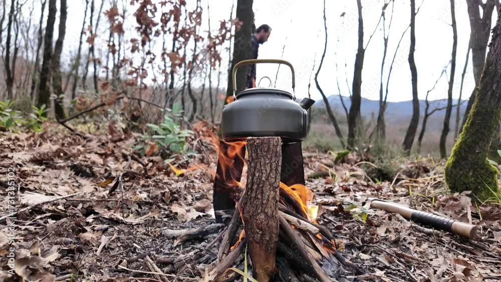 Camper collets brushwoods to stoke up the camping fire in a forest. Camper collets brushwoods to stoke up the camping fire in a forest.