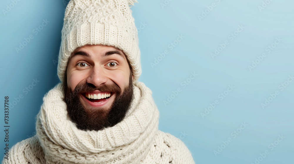Cheerful man wearing scarf and knitted hat isolated on pastel background with space for text