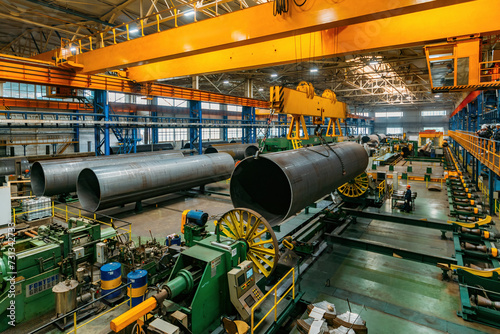 Finished pipe transportation by overhead crane in pipe factory photo