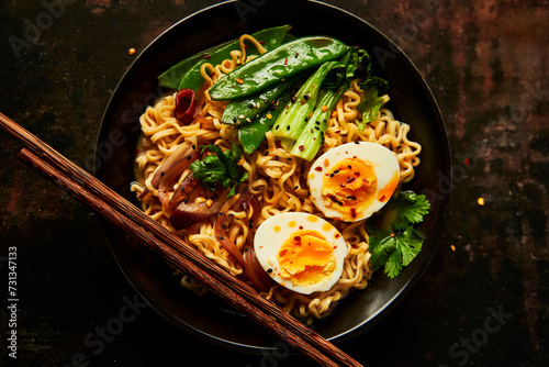 Egg and Vegetable Noodles in bowl with chopsticks photo