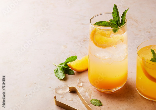 Orange sparkling cocktail with mint garnish photo