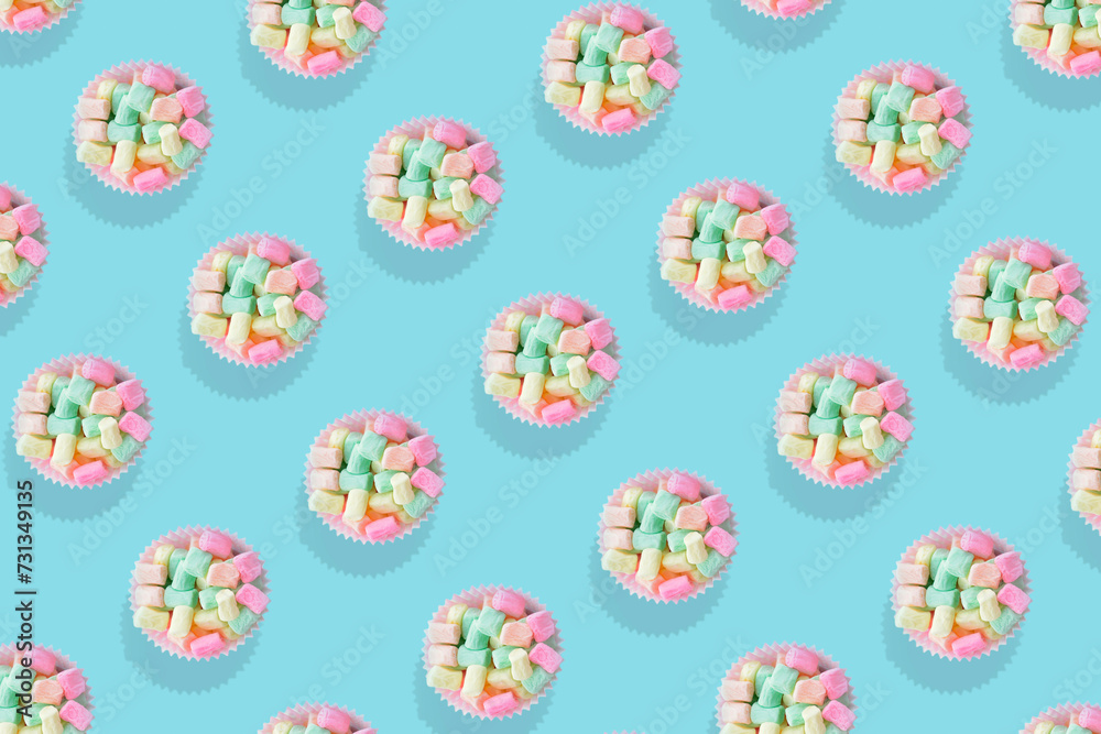 Modern retro color theme pattern of pastel candies against an aqua blue background. Modern retro color theme pattern of pastel candies against an aqua blue background.