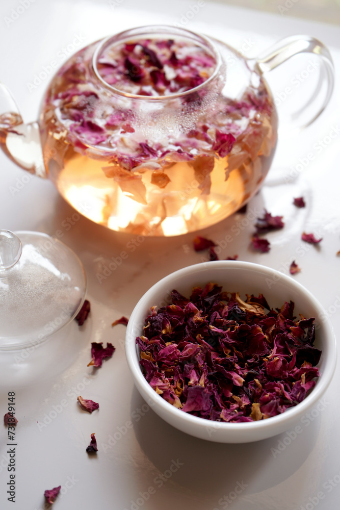 Rose petal herbal tea with dried flowers and teapot closeup. Rose petal herbal tea with dried flowers and teapot closeup.