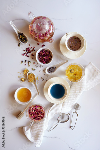 Selection of herbal teas, rose petal, calendula, lavender, and blue butterfly pea flower, known for their flavor, medicinal and nutritional properties. photo