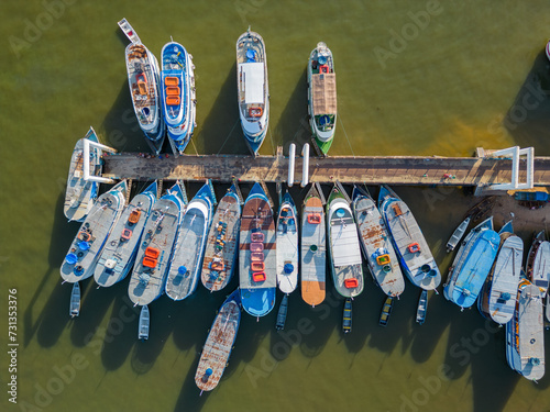 Aerial drone view showcasing boats neatly lined along the pier on the Tapajos river in Santarem, Brazil photo