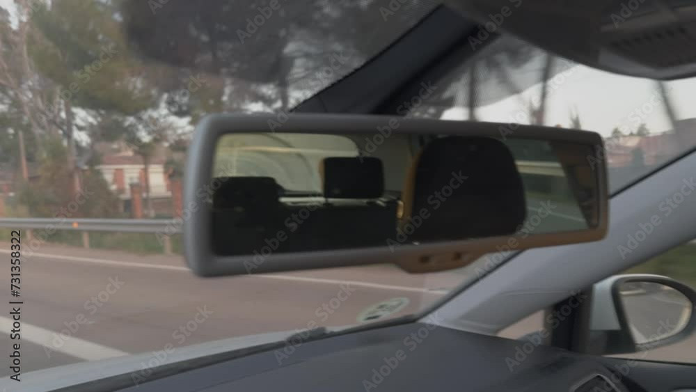 Close-up shot of hand driving a car showing the road
Close-up shot of hand driving a car showing the road