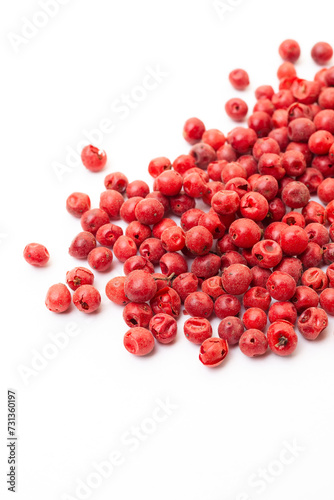 Red peppercorns on white background. Organic spice. Dry red pepper grain. 