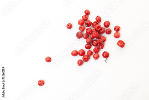 Red peppercorns on white background. Organic spice. Dry red pepper grain. 