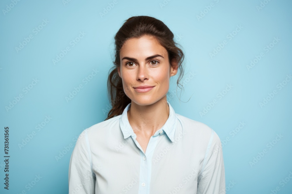 Portrait of a beautiful young business woman on a blue background. Portrait of a beautiful young business woman on a blue background.