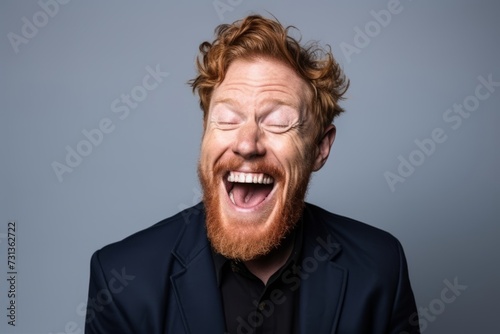 Handsome redhead man with beard and glasses yawning. © Inigo