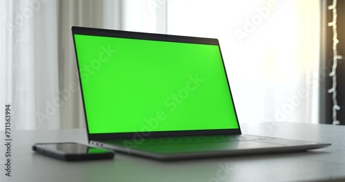 Laptop home office with green screen where you can add any image to the laptop monitor. 