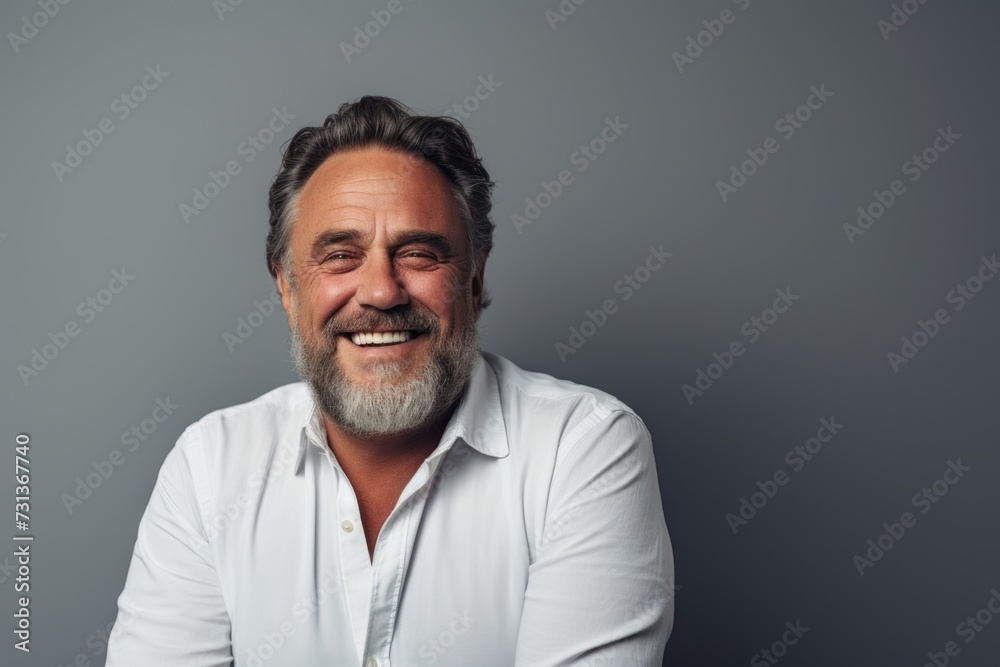 Portrait of a smiling middle-aged man in a white shirt. Portrait of a smiling middle-aged man in a white shirt.