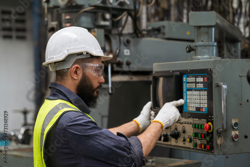 Engineering manager and mechanic worker check up in industrial factory. Professional technician using computer in an industrial factory