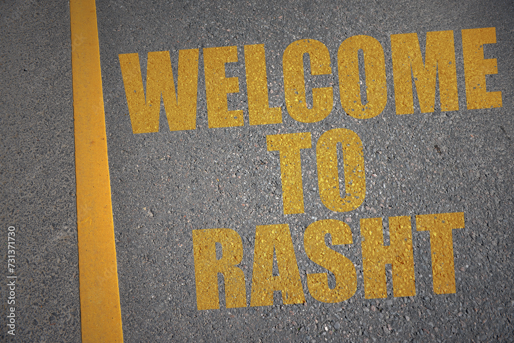 asphalt road with text welcome to Rasht near yellow line.