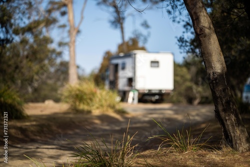 camping in a tent and van in the australian bush. Caravan camping at a camp ground off grid on a holiday in spring.