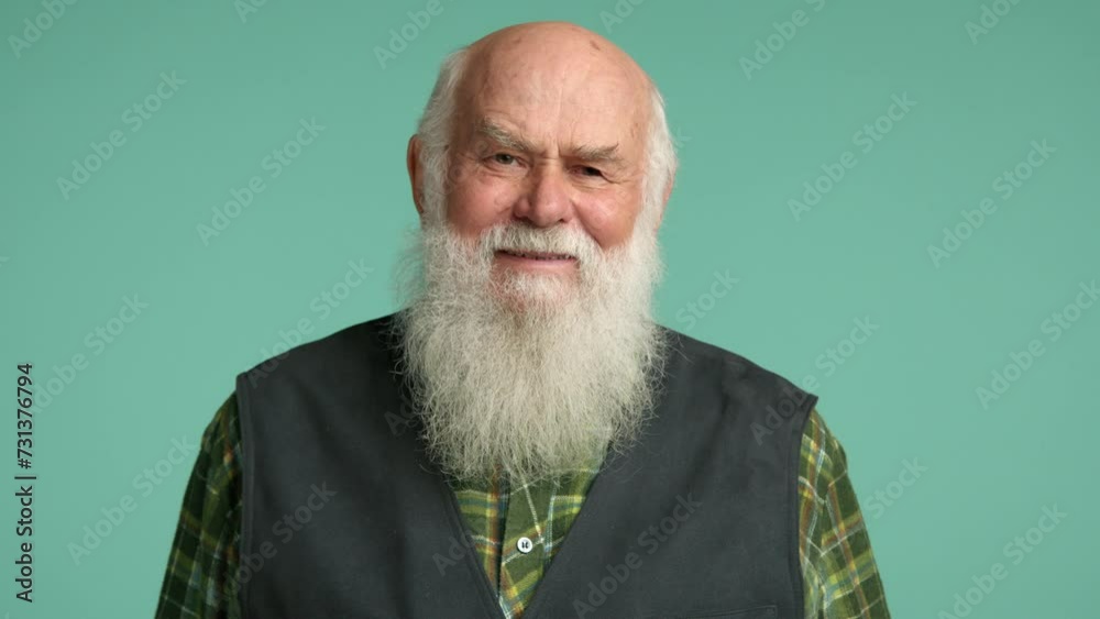 Joyful elderly man with a full white beard laughing heartily in a green plaid shirt and denim vest, set against a teal backdrop. Capturing a moment of genuine happiness. Camera 8K RAW. Joyful elderly man with a full white beard laughing heartily in a green plaid shirt and denim vest, set against a teal backdrop. Capturing a moment of genuine happiness. Camera 8K RAW.
