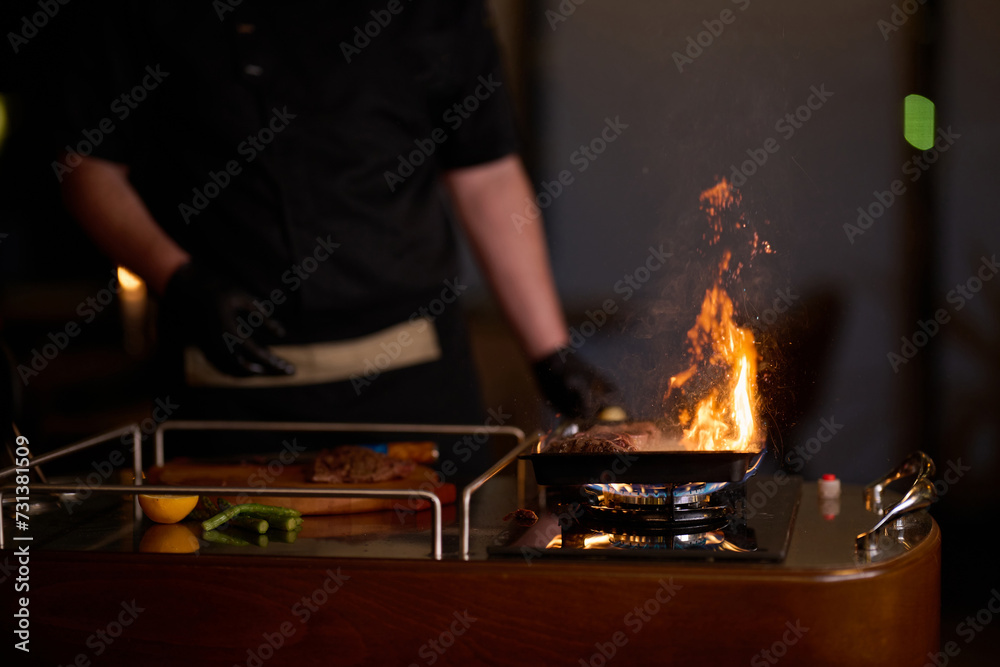 Close-up shot, a professional chef expertly prepares a delicious steak using modern cooking techniques, showcasing culinary excellence and precision in the art of gourmet cuisine