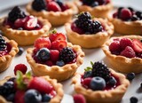 Delicious tartlets with berries on a white plate. Selective focus.