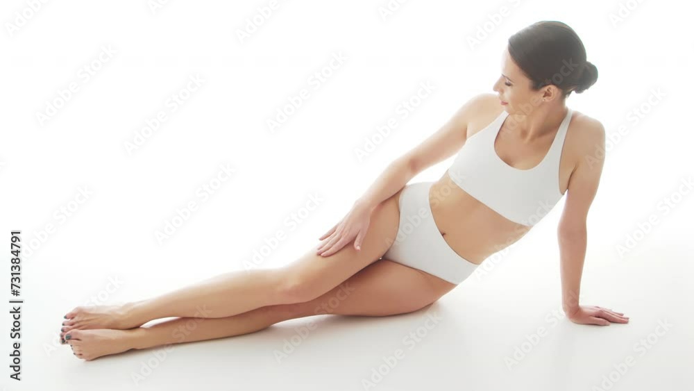 Beautiful woman in white underwear over isolated white background. Studio video of healthy young girl in swimsuit. Health and skin care, wellness, dieting and cosmetics concept. Beautiful woman in white underwear over isolated white background. Studio video of healthy young girl in swimsuit. Health and skin care, wellness, dieting and cosmetics concept.