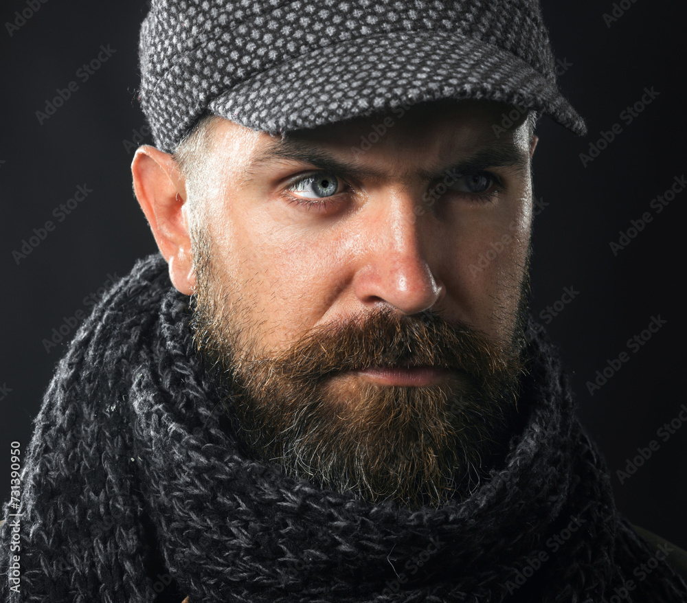 Closeup portrait serious bearded man in gray cap and scarf. Men fashion. Fashionable handsome man with beard and mustache in demi-season clothes. Winter knitwear. Fashion male model in winter outfit. Closeup portrait serious bearded man in gray cap and scarf. Men fashion. Fashionable handsome man with beard and mustache in demi-season clothes. Winter knitwear. Fashion male model in winter outfit.