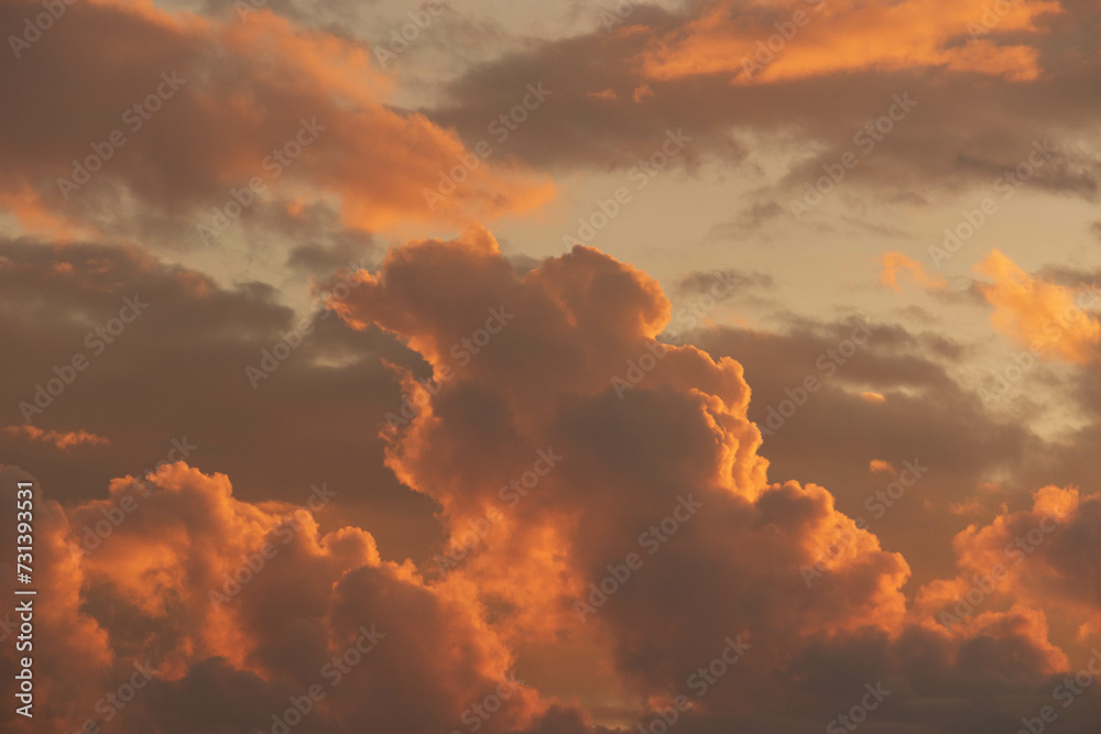 Fototapeta premium Orange Sunset background with different textures and colors in the clouds.