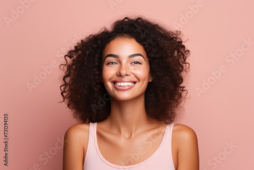 Portrait of smiling young african american woman with curly hair.
