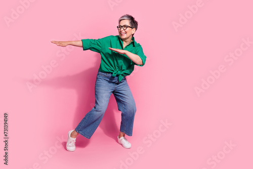 Full size photo of pretty retired female dancing celebration bachelorette party wear trendy green outfit isolated on pink color background