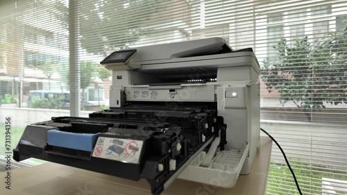 Close-up of removing empty printer ink from a printer in an office. photo