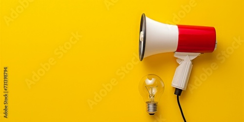 Red and white megaphone and light bulb on yellow background, marketing ideas concept