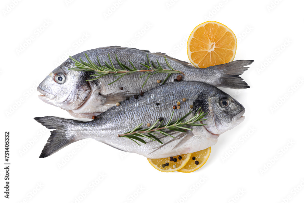 Raw dorado fish, lemon and spices isolated on white, top view