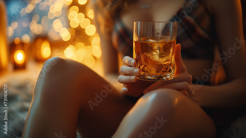close up of woman's leg with body and hands Woman holding a whisky drink, sexy woman with alcohol drink photo