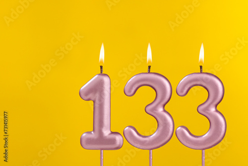 Candle 133 with flame - Birthday card on yellow luxury background