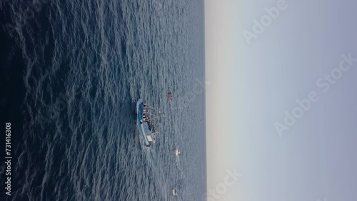 Vertical view of a fishing boat sailing on the mediterranean sea, Catalunya, Spain photo