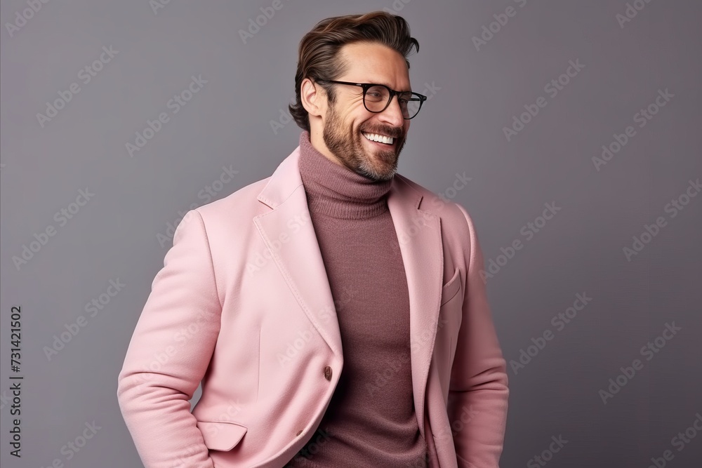 Portrait of a handsome young man in a pink jacket and glasses. Portrait of a handsome young man in a pink jacket and glasses.