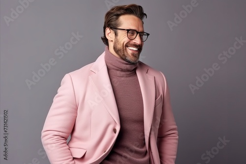 Portrait of a handsome young man in a pink jacket and glasses. © Inigo
