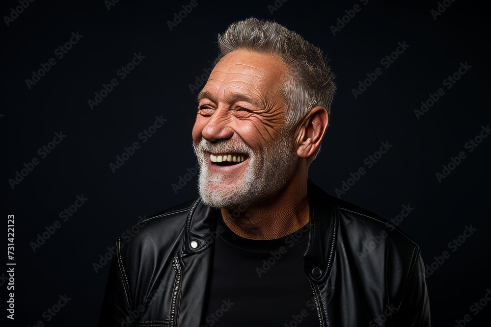 Portrait of a happy senior man with a beard on a black background. Portrait of a happy senior man with a beard on a black background.