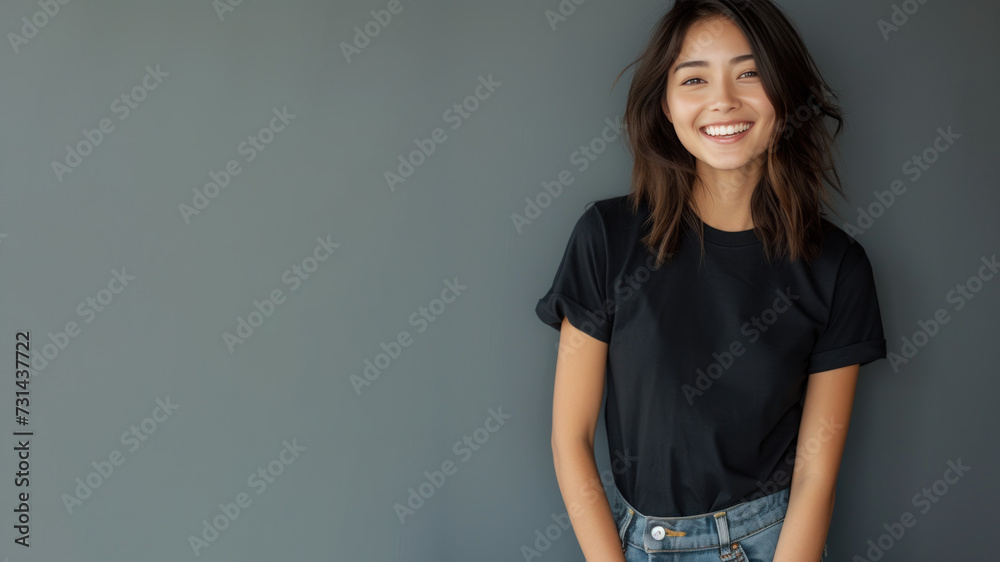 Asian young woman wear black t-shirt smile isolated on grey background Asian young woman wear black t-shirt smile isolated on grey background