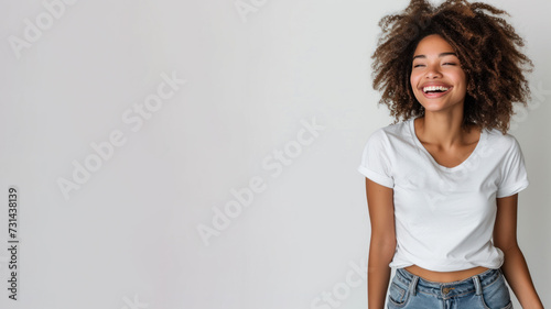 Afro woman wear white t-shirt smile isolated on grey background photo