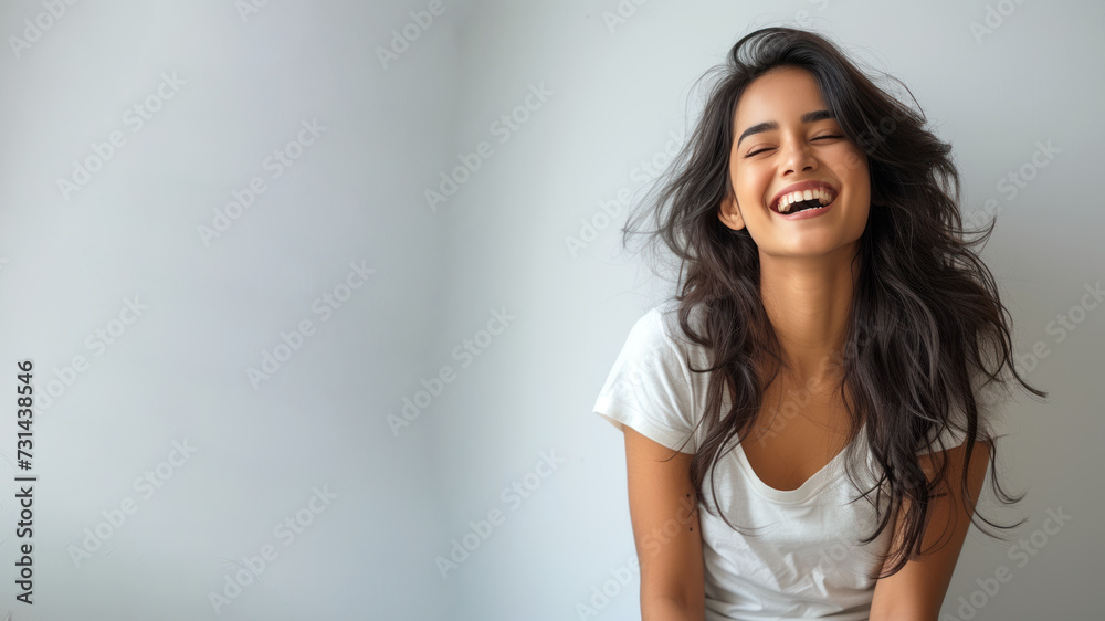 Indian woman wear white t-shirt smile isolated on grey background Indian woman wear white t-shirt smile isolated on grey background