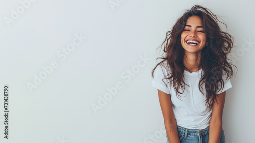 Indian woman wear white t-shirt smile isolated on grey background photo