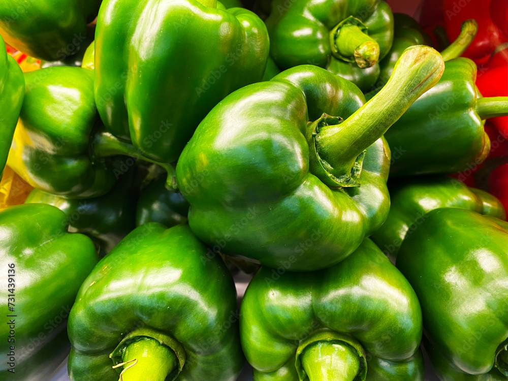 Freshly picked green bell peppers on display at the market Freshly picked green bell peppers on display at the market