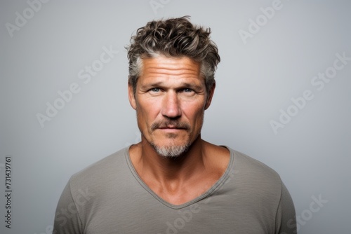 Portrait of a middle-aged man with grey hair and grey t-shirt.