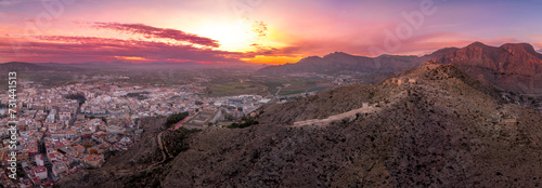 Aerial view of Orihuela in Murcia province Spain medieval town with castle and Gotchic and Baroque churches near the Segura river with dramatic colorful sunset sky photo