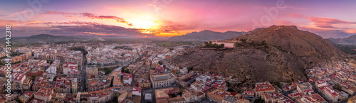Aerial view of Orihuela in Murcia province Spain medieval town with castle and Gotchic and Baroque churches near the Segura river with dramatic colorful sunset sky photo