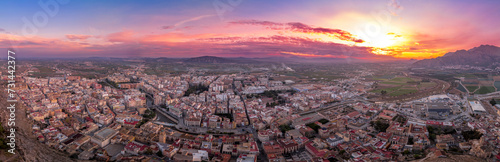Aerial view of Orihuela in Murcia province Spain medieval town with castle and Gotchic and Baroque churches near the Segura river with dramatic colorful sunset sky