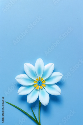 A single blue flower with a yellow center and green stem sits against a blue background. ai generative © Big